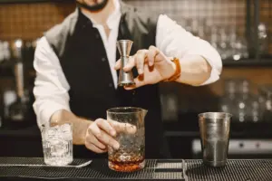 A bartender mixing a cocktail