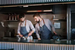 A chef preparing a dish in a restaurant kitchen