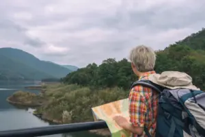 A traveller with a backpack looking at a map